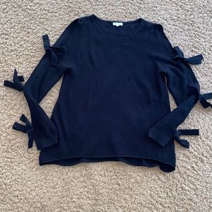 Black sweater with open sleeves and bow detail